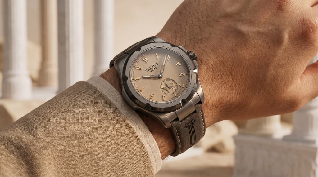 Takhte-Watch worn on wrist against Persian architectural backdrop